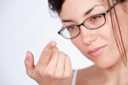 woman inserting contact lenses